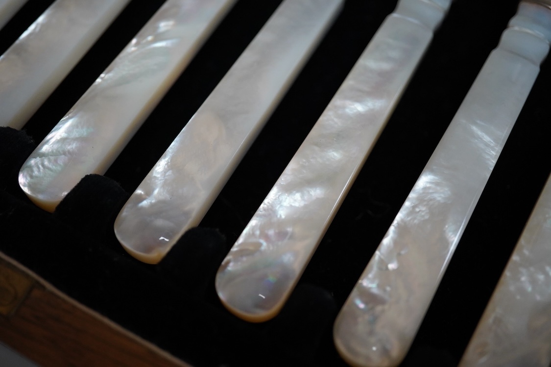 A set of twelve pairs of George V mother of pearl handled silver dessert eaters, by Roberts & Belk, Sheffield, 1926, knife 19.3cm, in a fitted oak box.